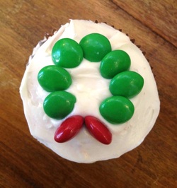 Christmas wreath cupcake with red candy berries and green icing